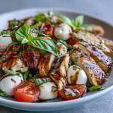 Grilled chicken slices, fresh mozzarella, and ripe tomatoes combine in this vibrant Caprese Chicken Bowl with basil and balsamic glaze.