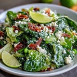 Bright lemon vinaigrette spring salad with radishes and peas in a white bowl, showcasing vibrant green peas, sliced radishes, and mixed spring greens drizzled with zesty lemon dressing.