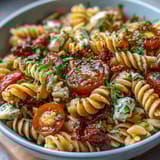 Refreshing summer pasta salad featuring crisp cucumbers, bell peppers, and cherry tomatoes tossed in Italian dressing.  