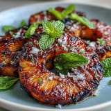 Sweet grilled pineapple spears topped with melting citrusy yuzu kosho butter and mint.