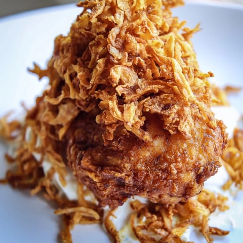 Savory Crispy Onion Chicken Sandwich features juicy buttermilk-marinated chicken, crispy fried onions, and fresh lettuce on a buttery toasted bun.