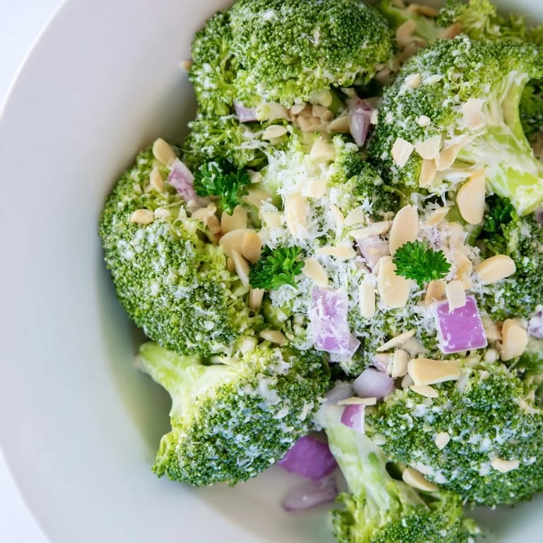 Bright, fresh Garlic Parmesan Broccoli Salad with crisp florets and creamy dressing, ready to serve alongside grilled chicken or fish.